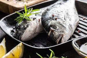 Mediterranean fish bream with spices salt herbs garlic and lemon. Healthy seafood. Concept of healthy sea food.